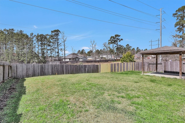 view of yard featuring a gazebo and a fenced backyard