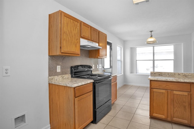 13757 Bighorn Trl, Willis, TX 77378 - kitchen featuring electric range, under cabinet range hood, backsplash, light tile patterned flooring, and baseboards