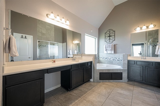 bathroom with a bath, a stall shower, a sink, and lofted ceiling