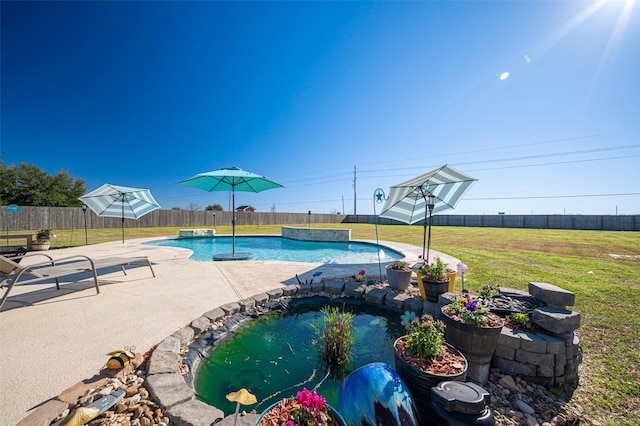 view of swimming pool featuring a fenced in pool, a fenced backyard, and a lawn