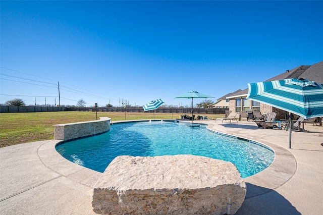 view of pool featuring a yard, a patio area, fence, and a fenced in pool