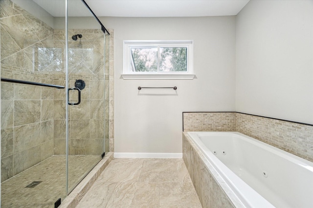 bathroom with a shower stall, a jetted tub, and baseboards