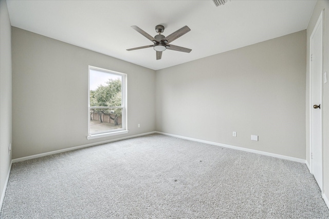 unfurnished room with visible vents, carpet, a ceiling fan, and baseboards