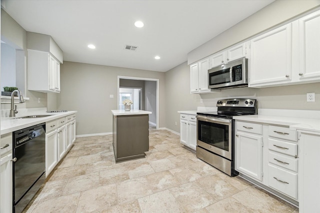 kitchen with a sink, visible vents, baseboards, white cabinetry, and appliances with stainless steel finishes