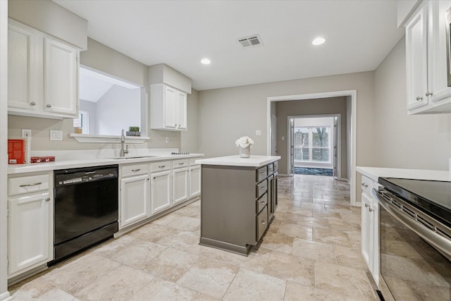 kitchen with light countertops, dishwasher, and white cabinetry