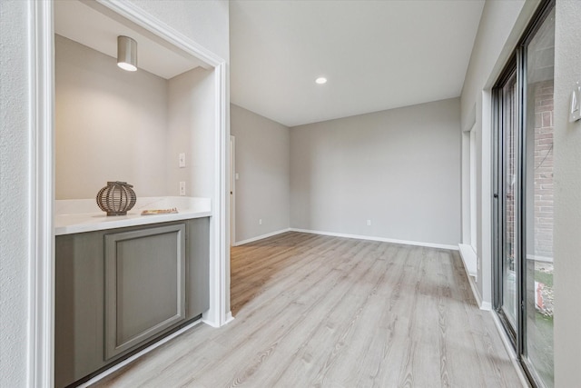 bar featuring light wood finished floors and baseboards