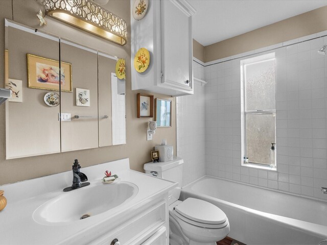 full bathroom with  shower combination, vanity, and toilet