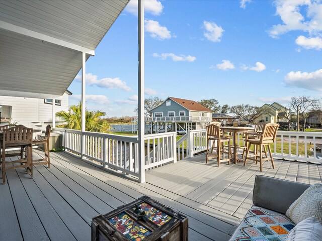 wooden terrace with outdoor dining space