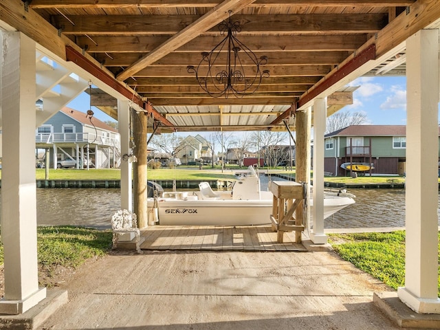 view of patio featuring a boat dock, a water view, and a residential view