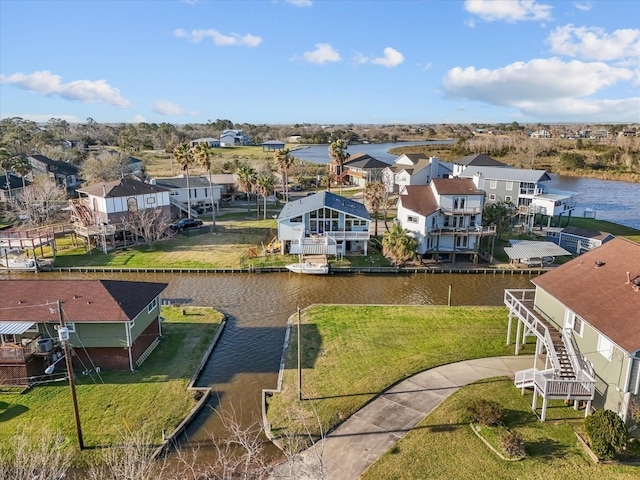 drone / aerial view featuring a water view and a residential view