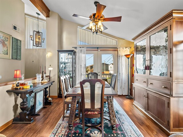 dining area with ceiling fan, dark wood-type flooring, visible vents, vaulted ceiling, and french doors