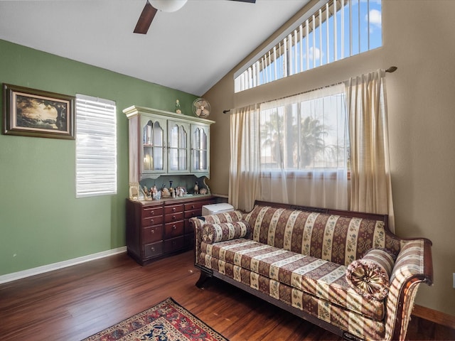 living room featuring plenty of natural light, baseboards, vaulted ceiling, and dark wood-type flooring