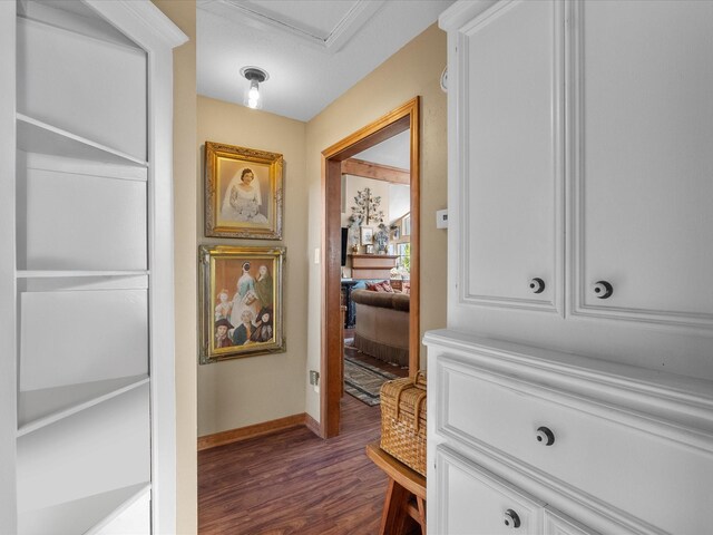 hallway featuring dark wood-style floors and baseboards