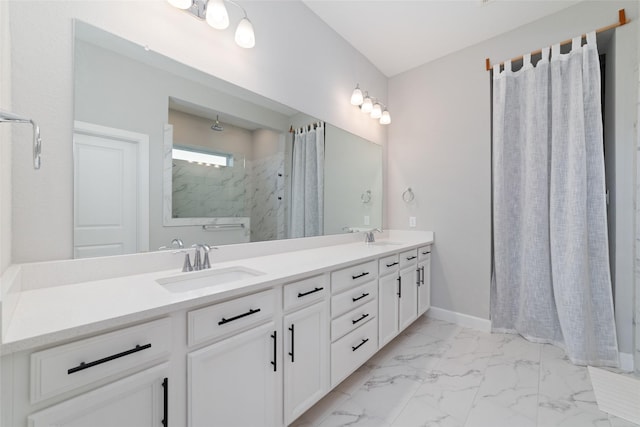 bathroom featuring double vanity, marble finish floor, a marble finish shower, and a sink
