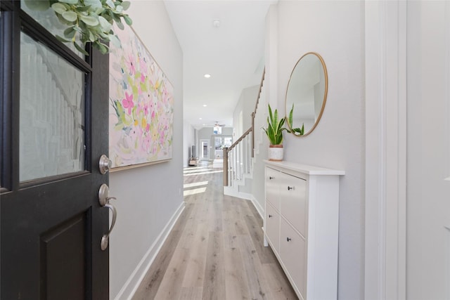 interior space with stairway, recessed lighting, light wood-style flooring, and baseboards