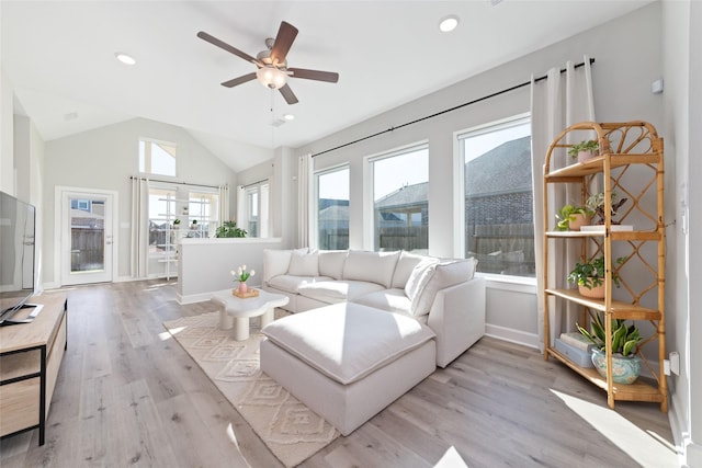 living area with recessed lighting, light wood-style flooring, a ceiling fan, vaulted ceiling, and baseboards