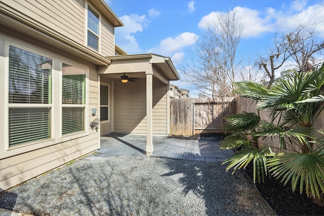 exterior space featuring a patio area, ceiling fan, and fence