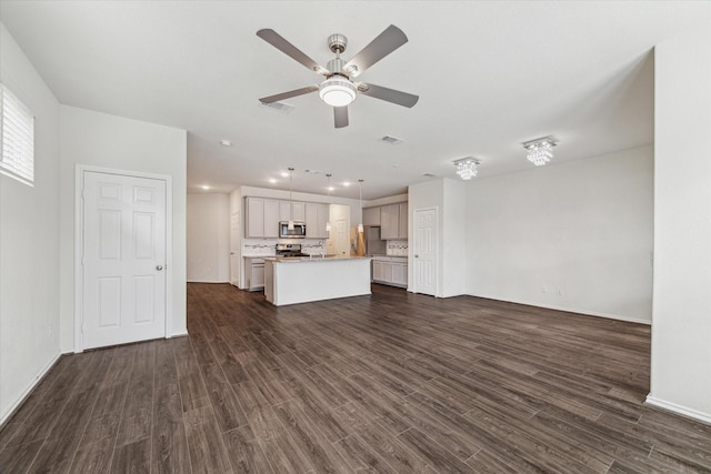 unfurnished living room featuring dark wood-style floors, visible vents, and a ceiling fan