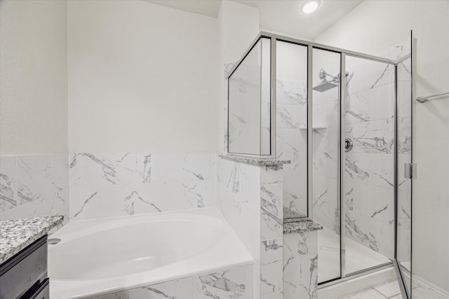 full bathroom featuring a garden tub, vanity, and a marble finish shower