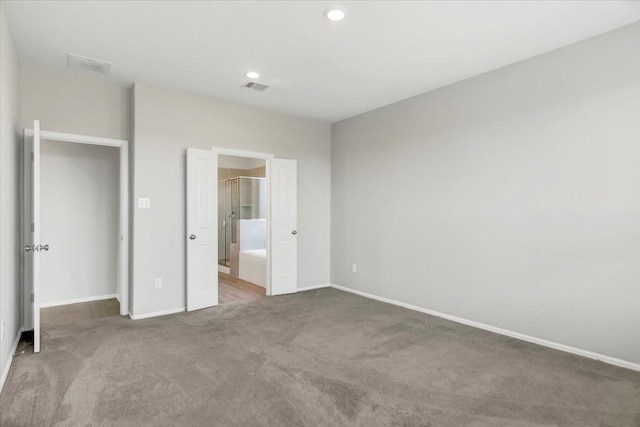 unfurnished bedroom featuring baseboards, visible vents, and carpet flooring