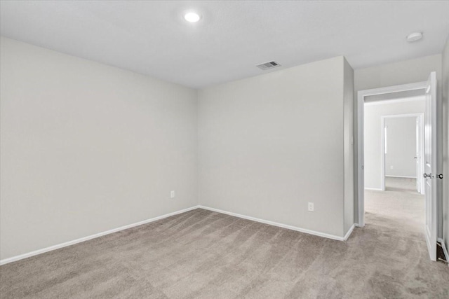 unfurnished room with recessed lighting, visible vents, light carpet, and baseboards