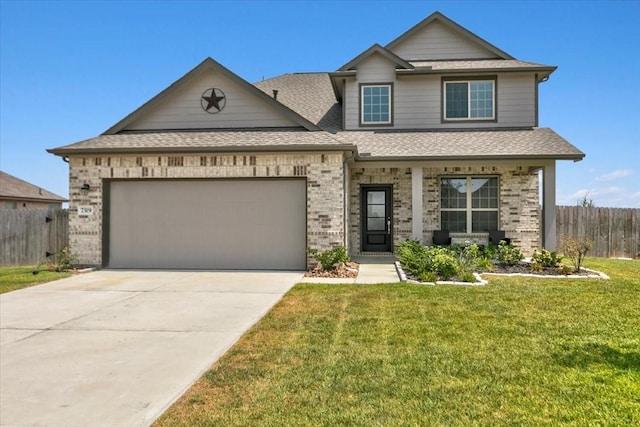 view of front of house with a front lawn, an attached garage, fence, and brick siding