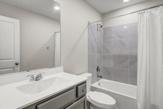 bathroom with toilet, shower / bath combination with curtain, and vanity