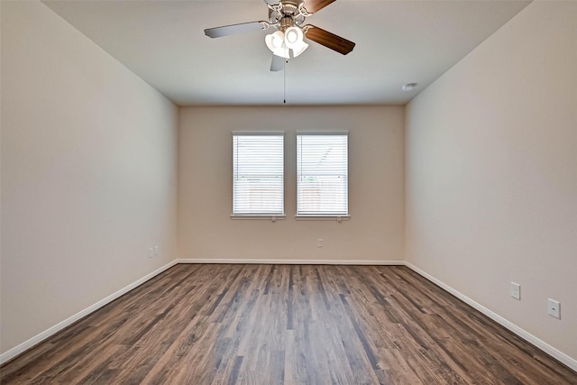 empty room featuring dark wood-style floors, baseboards, and a ceiling fan