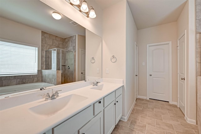 bathroom featuring double vanity, a stall shower, baseboards, and a sink