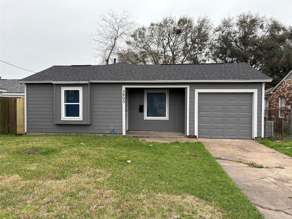 ranch-style home with a front yard, concrete driveway, fence, and an attached garage