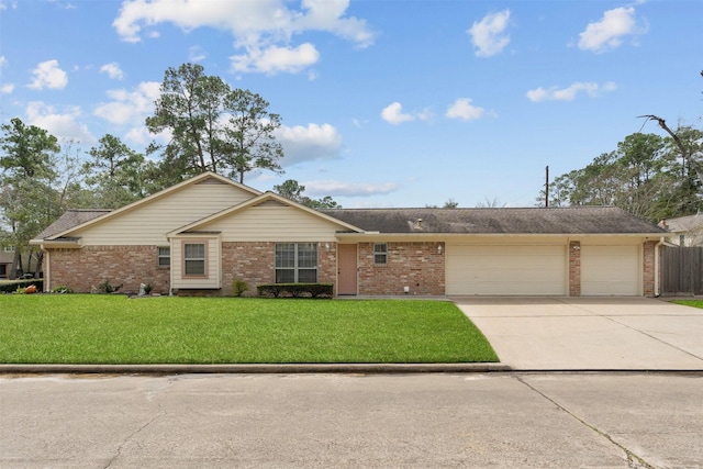 single story home featuring driveway, a front lawn, an attached garage, and brick siding