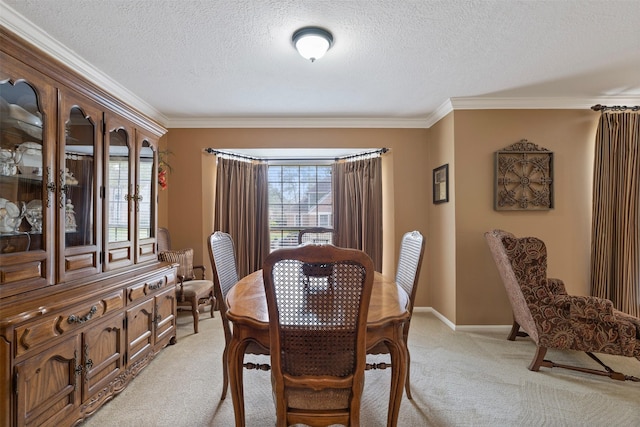 dining area with light carpet, a textured ceiling, baseboards, and crown molding