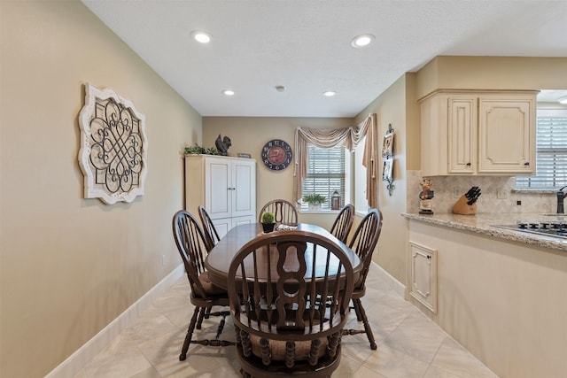 dining room featuring recessed lighting, baseboards, and light tile patterned floors