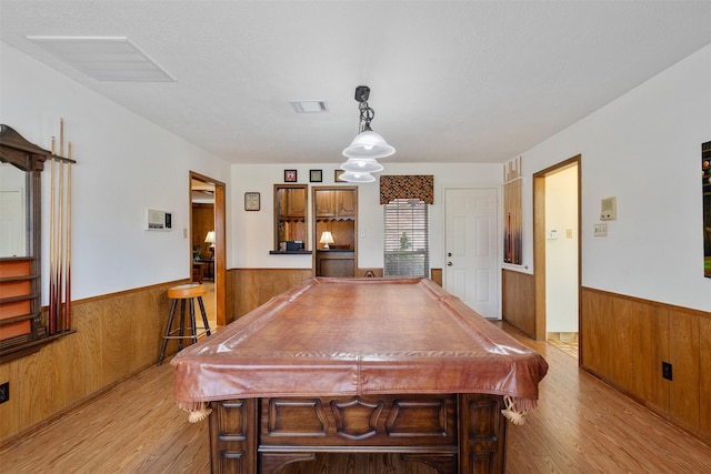 playroom featuring a wainscoted wall, visible vents, and wood walls