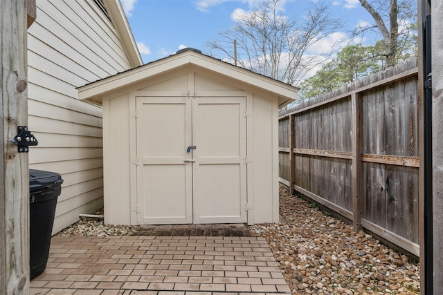 view of shed featuring fence