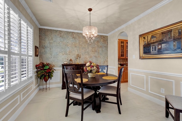 dining space featuring ornamental molding, a healthy amount of sunlight, and a decorative wall