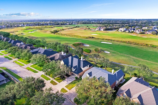 birds eye view of property with view of golf course and a residential view