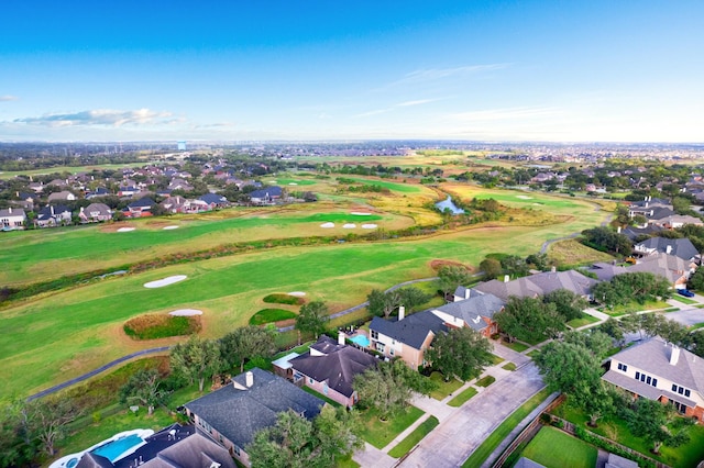 drone / aerial view with golf course view and a residential view