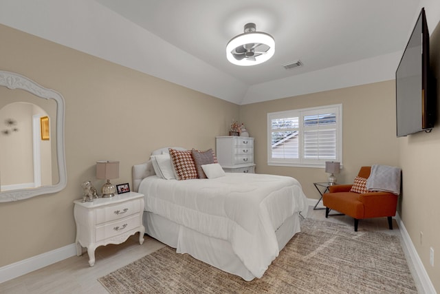 bedroom featuring visible vents, vaulted ceiling, and baseboards