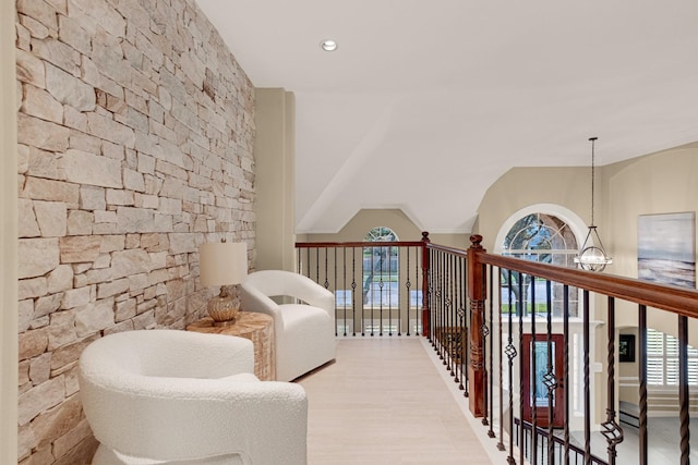 living area with wood finished floors, a wealth of natural light, and recessed lighting