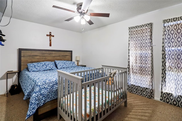 bedroom featuring a ceiling fan and a textured ceiling