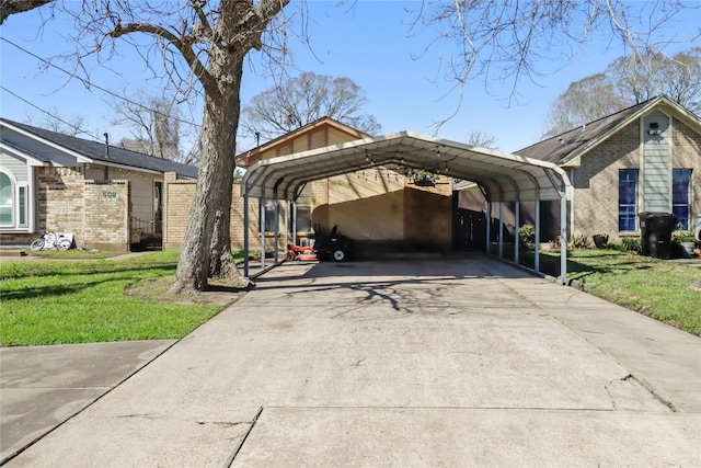 view of side of property with a carport, a lawn, and driveway