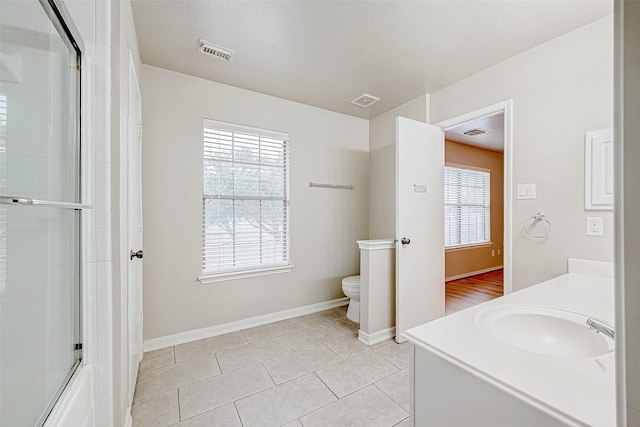 bathroom with tile patterned flooring, visible vents, and toilet