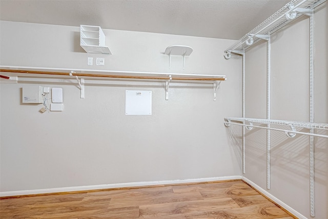 spacious closet with light wood-style floors