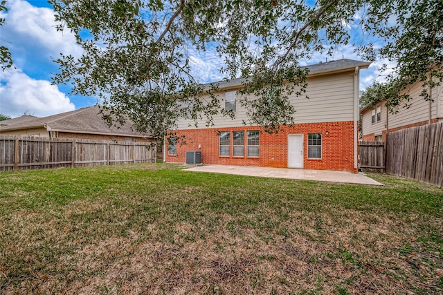 back of house with a fenced backyard, cooling unit, a yard, a patio area, and brick siding