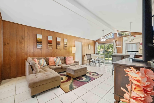 living area with vaulted ceiling with beams, wood walls, ceiling fan, and light tile patterned floors