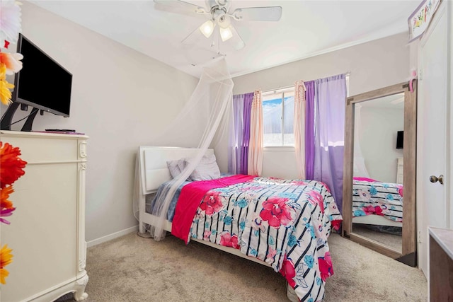 bedroom with light carpet, ceiling fan, and baseboards