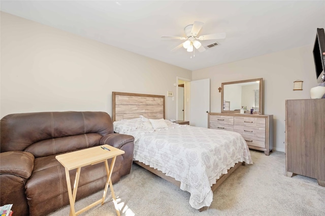 bedroom featuring a ceiling fan, light carpet, visible vents, and baseboards