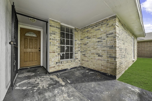 property entrance with brick siding