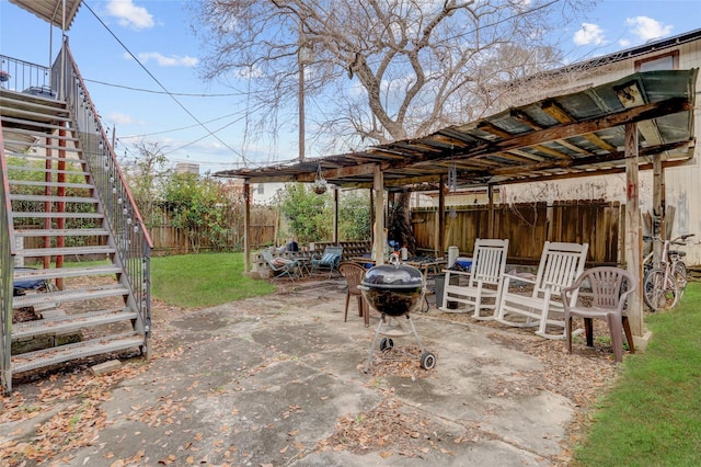 view of patio / terrace featuring a fire pit, a fenced backyard, and stairway